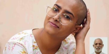 Varsha Kumawat poses for a photograph after shaving her head to donate hair for the cancer patients