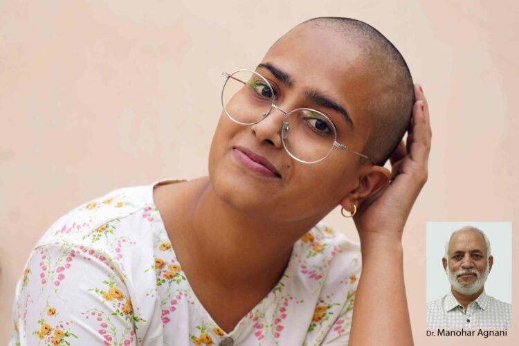 Varsha Kumawat poses for a photograph after shaving her head to donate hair for the cancer patients