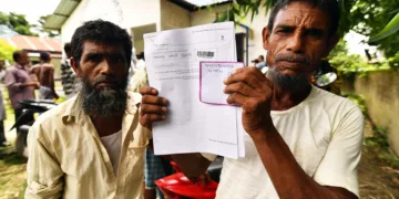 A resident holds documents on his way to check their names on the final list of National Register of Citizens (NRC) at a NRC Sewa Kendra (NSK) in Kuranibori village in Morigoan district on July 30, 2018.
India on July 30 stripped four million people of citizenship in the northeastern state of Assam, under a draft list that has sparked fears of deportation of largely Bengali-speaking Muslims. Critics say it is the latest move by right-wing Prime Minister Narendra Modi to advance the rights of India's Hindu majority at the expense of its many minorities, in particular its over 170 million Muslims.
 / AFP PHOTO / Biju BORO