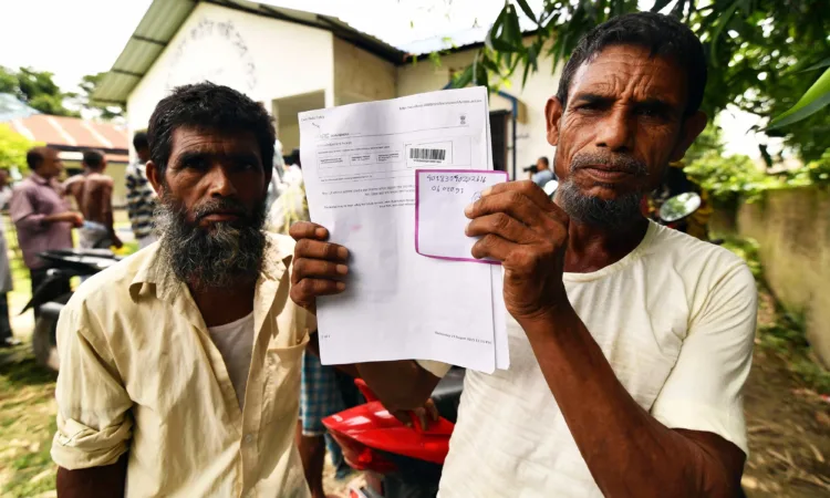 A resident holds documents on his way to check their names on the final list of National Register of Citizens (NRC) at a NRC Sewa Kendra (NSK) in Kuranibori village in Morigoan district on July 30, 2018.
India on July 30 stripped four million people of citizenship in the northeastern state of Assam, under a draft list that has sparked fears of deportation of largely Bengali-speaking Muslims. Critics say it is the latest move by right-wing Prime Minister Narendra Modi to advance the rights of India's Hindu majority at the expense of its many minorities, in particular its over 170 million Muslims.
 / AFP PHOTO / Biju BORO