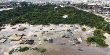 Aerial view of flooded streets at the Sarandi neighborhood in Porto Alegre, Rio Grande do Sul state, Brazil on May 5, 2024. - The challenge is titanic and against the clock: authorities and neighbours are trying to avoid an even greater tragedy than the one already experienced in the Brazilian state of Rio Grande do Sul, where 66 people died and 80,000 were displaced by the floods, according to the authorities. (Photo by Carlos Fabal / AFP)