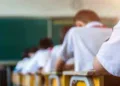 Rear view of middle school students studying in classroom