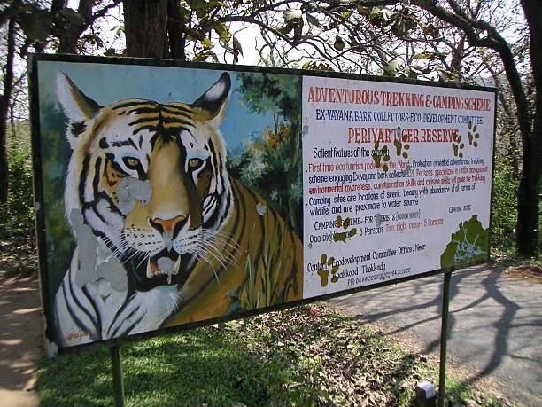 "Thekkady, India - March 25, 2006: Sign of Periyar Wildlife Park. Periyar National Park is a wildlife reseve located in Kerala, south India. The Nationalpark is located in the mountainous area of the Cardamon Hills near the border to the indian state of Tamil Nadu. The National Park is a protected reserve  for tigers , elephants and the nilgiri tar."