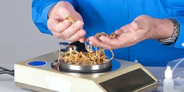 This picture of a penny weight scale symbolizes selling old gold equals lots of cash