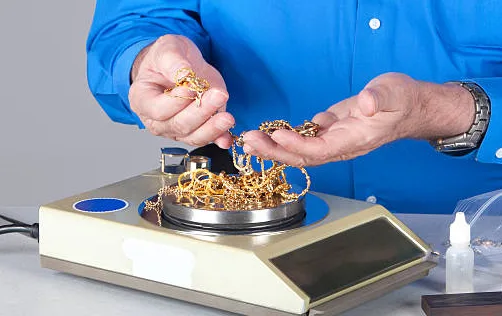 This picture of a penny weight scale symbolizes selling old gold equals lots of cash