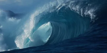 Large powerful blue ocean wave breaking in slow motion, filmed in the deep waters off the coast of South Western Australia.