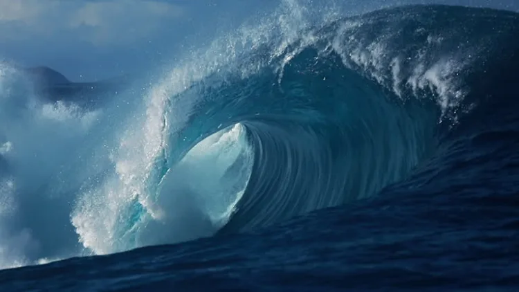 Large powerful blue ocean wave breaking in slow motion, filmed in the deep waters off the coast of South Western Australia.