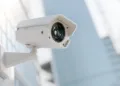 CCTV camera installed on wall of the building. Scan the area for surveillance purposes. Can be used background in security work. 3D Render