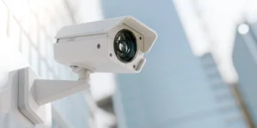 CCTV camera installed on wall of the building. Scan the area for surveillance purposes. Can be used background in security work. 3D Render