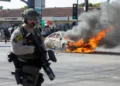 A car burns during a protest following federal immigration operations, in the Compton neighborhood of Los Angeles, California on June 7, 2025. US President Donald Trump deployed 2,000 troops on June 7, 2025 to handle escalating protests against immigration enforcement raids in the Los Angeles area, a move the state's governor termed "purposefully inflammatory." Federal agents clashed with angry crowds in a Los Angeles suburb as protests stretched into a second night Saturday, shooting flash-bang grenades and shutting part of a freeway amid raids on undocumented migrants, reports said. (Photo by RINGO CHIU / AFP)