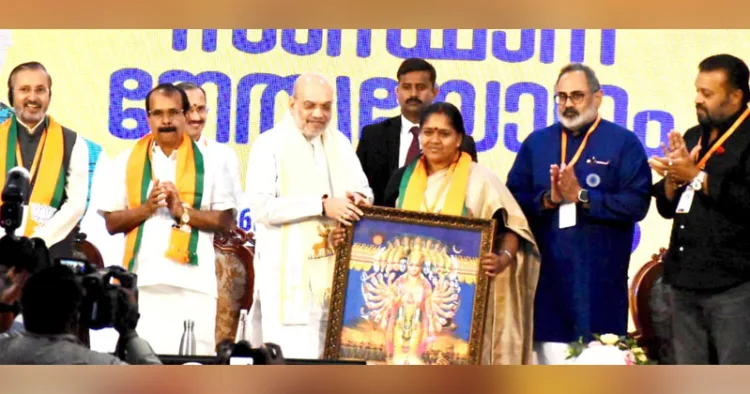 എറണാകുളത്ത് ബിജെപി സംസ്ഥാന നേതൃയോഗ വേദിയില്‍ കേന്ദ്ര ആഭ്യന്തര മന്ത്രി അമിത്ഷായ്ക്ക് പാര്‍ട്ടി സംസ്ഥാന ജന. സെക്രട്ടറി ശോഭാ സുരേന്ദ്രന്‍ ഉപഹാരം സമര്‍പ്പിക്കുന്നു