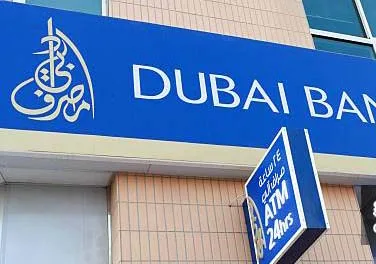 A logo stands outside Dubai Bank PJSC's Sheik Zayed Road branch in Dubai, United Arab Emirates, on Sunday, Oct. 16, 2011. Emirates NBD PJSC, the country's biggest lender by assets, said it will take over government-controlled Islamic lender Dubai Bank PJSC. Photographer: Duncan Chard/Bloomberg via Getty Images