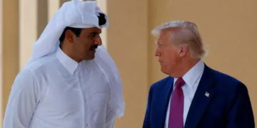 FILE PHOTO: U.S. President Donald Trump talks with Qatar's Emir Tamim bin Hamad Al Thani in Doha, Qatar, May 15, 2025. REUTERS/Brian Snyder/File Photo